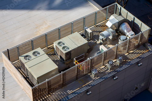 high angle birds-eye view of Manhattan New York City building rooftop with central ac units and ventilation
