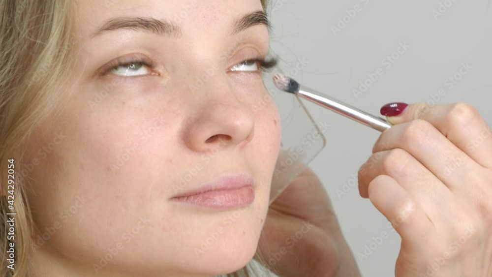 beautiful blonde in a beauty salon, does makeup beautiful blonde in a beauty salon, does makeup