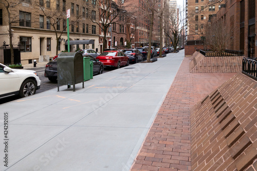 Tela Manhattan New York City concert  sidewalk walkway path with parked streetcars
