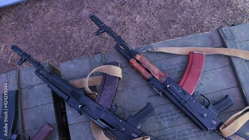 Kalashnikov assault rifles on military boxes.