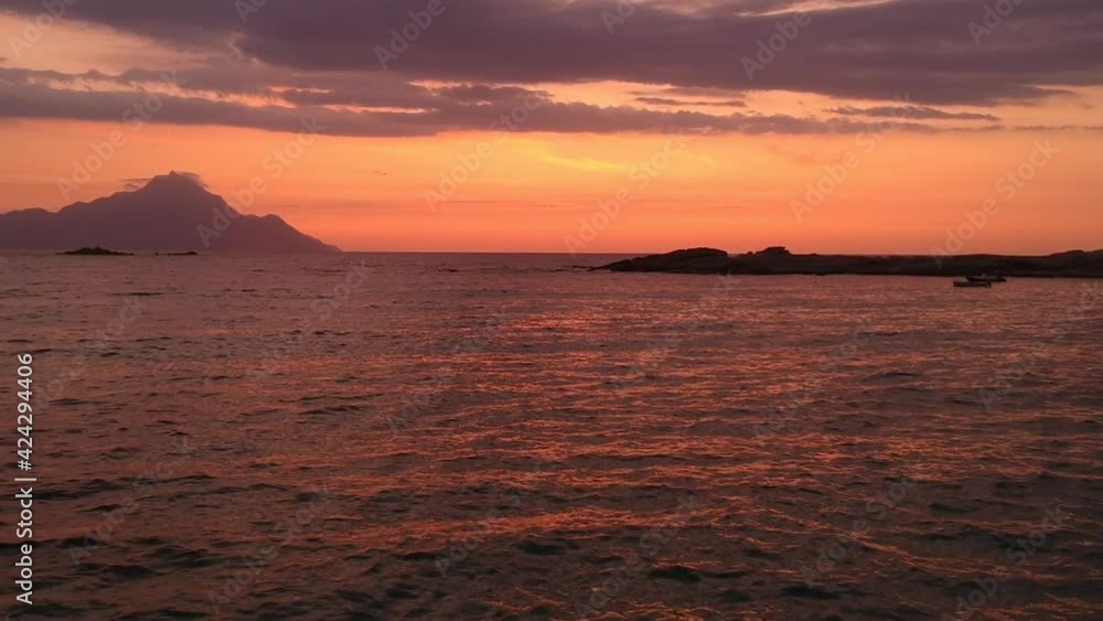 Aerial view of twilight above sea on sunset or sunrise, calm water, light waves and silhouettes Aerial view of twilight above sea on sunset or sunrise, calm water, light waves and silhouettes