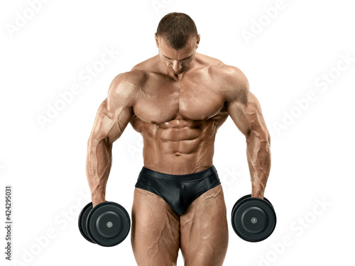 A muscular man with a perfect physique holds dumbbells in his hands. Classic bodybuilding. Isolated on white background