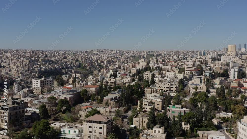 Drone video of the city on the slopes of the mountains in the Arabic style. Houses with roofs in a landscape city with narrow streets and roads, a city in the desert.Aerial view Amman Jordan. Drone video of the city on the slopes of the mountains in the Arabic style. Houses with roofs in a landscape city with narrow streets and roads, a city in the desert.Aerial view Amman Jordan.
