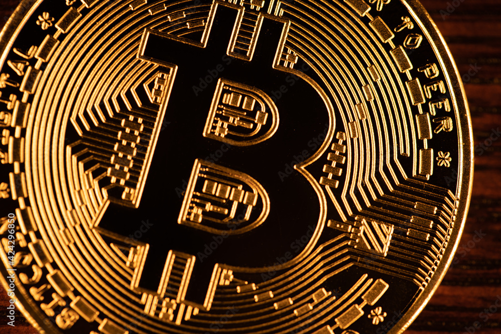 Golden bitcoin coin closeup. Bitcoins. Physical bit coins. Digital currency. Cryptocurrency mining concept.