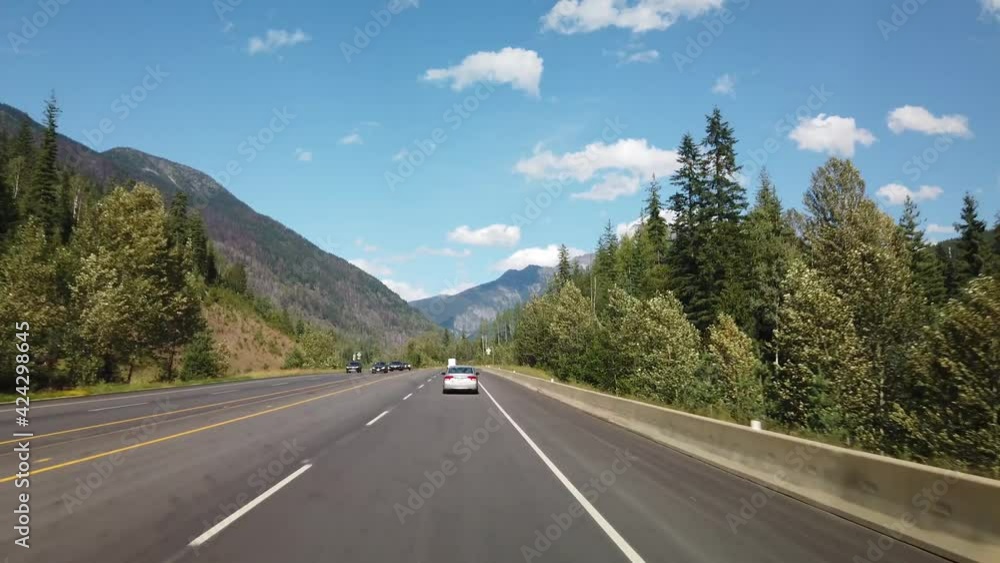 BRITISH COLUMBIA, CANADA - JULY 2019: Hyperlapse driving on highway during sunny summer day entering Revelstoke BRITISH COLUMBIA, CANADA - JULY 2019: Hyperlapse driving on highway during sunny summer day entering Revelstoke