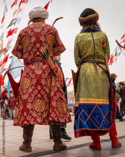 Ankara, Turkey - March 21 2021:  Back view of archer couple in old Turkish clothes