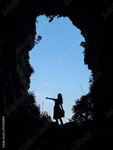 Girl standing at the entrance to the cave