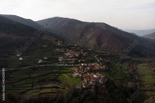Aerial panorama view of green agriculture farming terraces in remote rural mountain village town Sistelo Norte Portugal photo