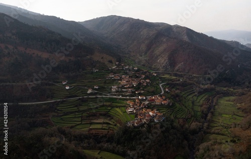 Aerial panorama view of green agriculture farming terraces in remote rural mountain village town Sistelo Norte Portugal photo