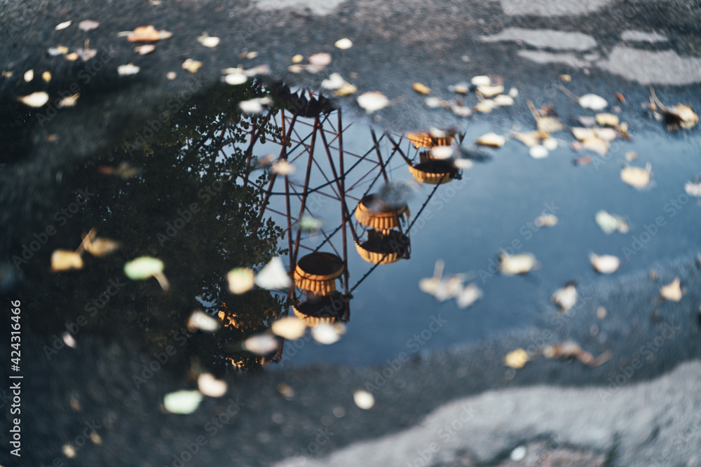 Chernobyl Ferries Wheel in reflection of a water puddle fairground - Autumn in Pripyat, Ukraine