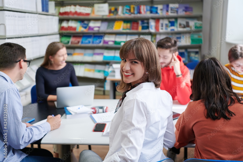 students group working on school project together on tablet computer at modern university