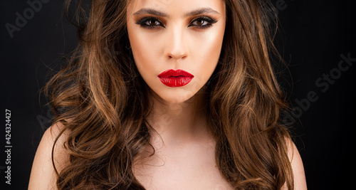 Elegant Fashion Model. Red lips, dark eyes makeup. Cosmetics products.