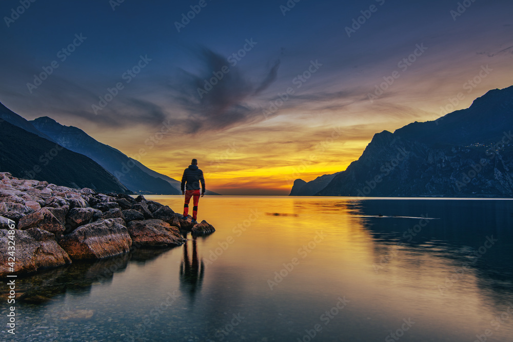 View of the beautiful Lake Garda surrounded by mountains, Scenic view of sunset at Lake Garda in the evening with the beautiful sunset colors, italy, Soft focus due to long exposure