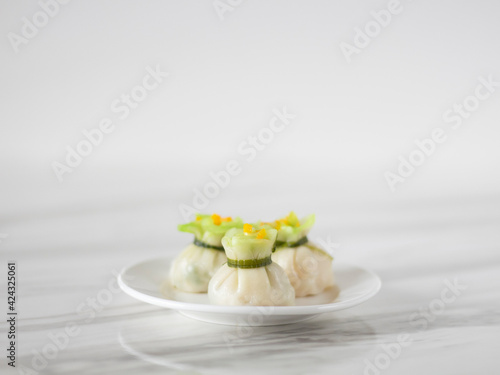 Steamed Money Bag Wontons on White Background with Copy Space. Chinese New Year Dim Sum. Chinese Fine Dining Har Gow (Crystal Shrimp Dumplings) Close Up.