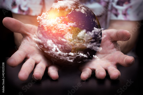 a man showing a little beautiful world on hands, protection the world concept	