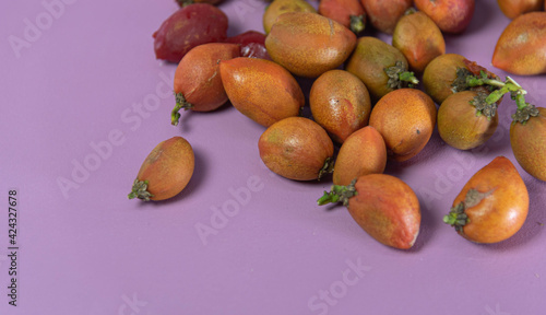 Caferana fruits (Bunchosia armeniaca) in natura on pink background. photo