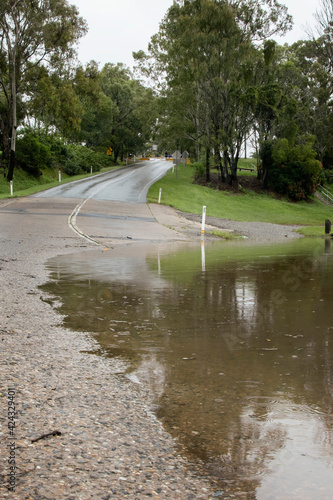 Queensland Australia 23 March 2021 Flooded Road after torrential rain and dam overflowing. River overflowing onto Youngs Crossing Petrie.