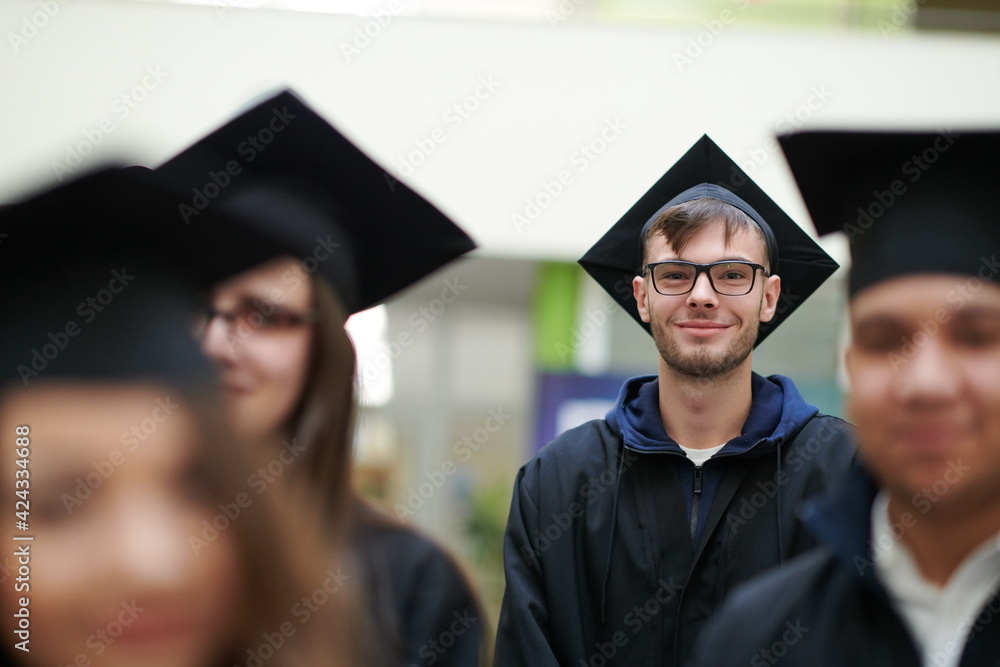 Fototapeta premium Group of diverse international graduating students celebrating