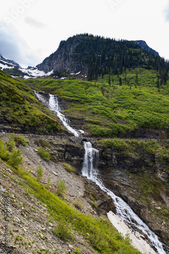 Going-to-the-Sun Road with roadside waterfall  Glacier National Park  Montana