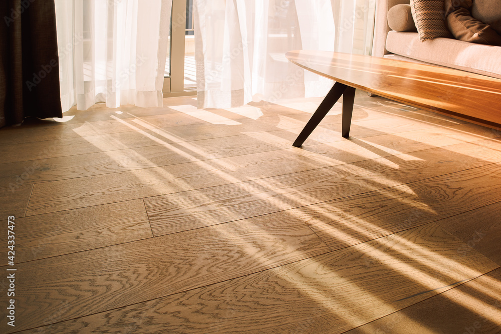 Modern room interior with an open window in minimal style. Transparent tulle with morning sun rays on shadow background Modern room interior with an open window in minimal style. Transparent tulle with morning sun rays on shadow background