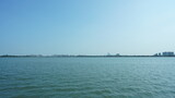 The panoramic lake view with the peaceful water and blue sky