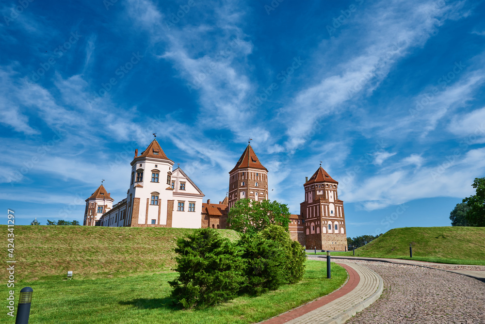 Fototapeta premium Mir castle complex in a summer day with blue cloudy sky. Tourism landmark in Belarus, cultural monument, old fortress