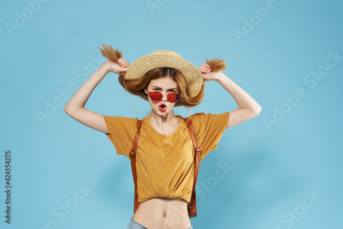 Cheerful pretty woman wearing sunglasses fashion blue summer background
