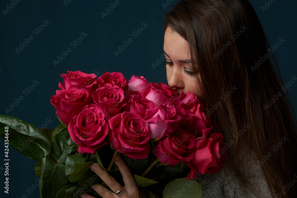 Young woman holding bouquet of roses flowers Young woman holding bouquet of roses flowers