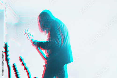 Tableau sur toile Bassist performing in a concert in double color exposure effect
