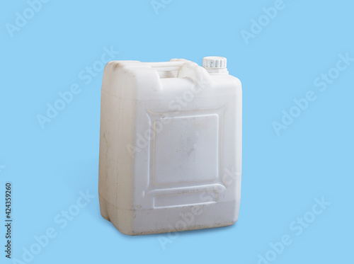 White dirt plastic jerry can isolated on a blue background photo