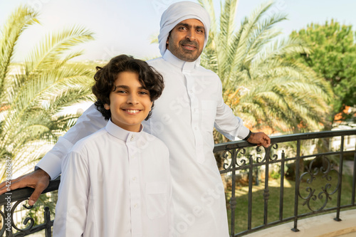 Arabian portrait of Father and Son enjoying time at home photo