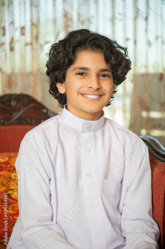 Young arabian boy smiling at home