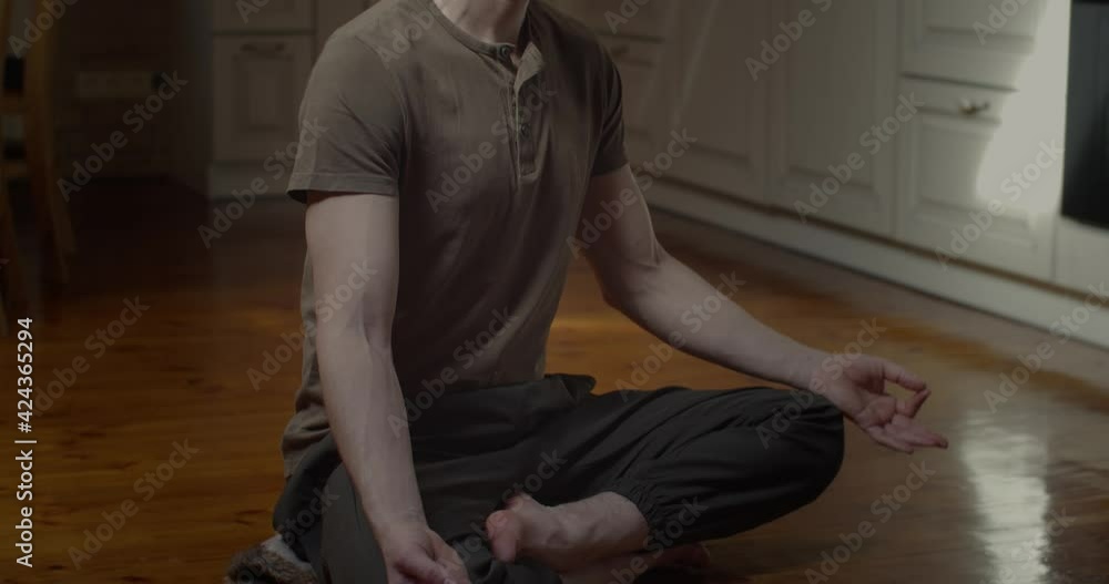 Tranquil man meditating in lotus pose alone at home background slow motion. Portrait of businessman freelancer practicing yoga to relax relief sliding shot. Meditation wellness concentration concept Tranquil man meditating in lotus pose alone at home background slow motion. Portrait of businessman freelancer practicing yoga to relax relief sliding shot. Meditation wellness concentration concept