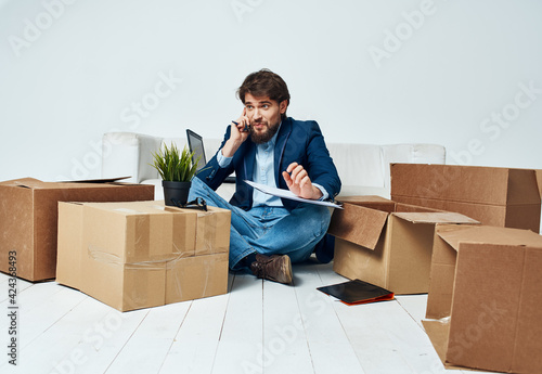 Man talking on the phone boxes with things moving official lifestyle