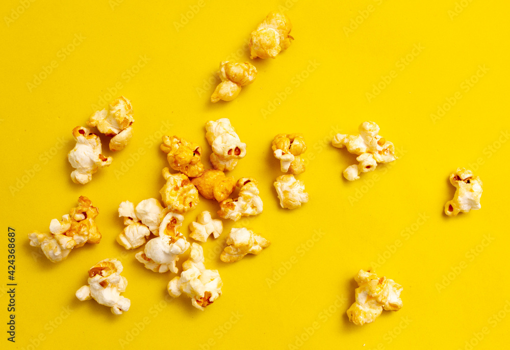 Close-up of popcorn on a yellow background. Close-up of popcorn on a yellow background.