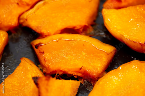 Pieces of pumpkin baked on a baking sheet. Food