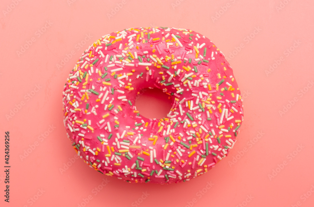Red donut on a pink background. Red donut on a pink background.
