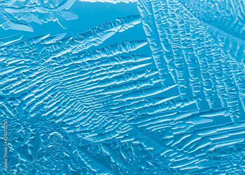 Blue patterns from frost on glass as a background.