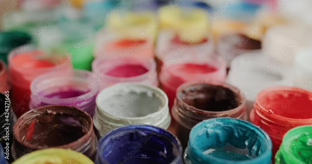 Lots of open cans of paint for drawing. 4K Slider shot Lots of open cans of paint for drawing. 4K Slider shot