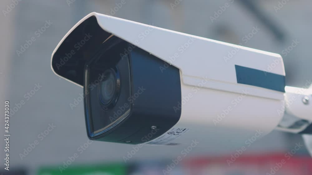 At sunlight security camera moving recording outside a building. CCTV surveillance. Privacy, urban, protection, house, system, control, secure, view, safe, video. Slow motion At sunlight security camera moving recording outside a building. CCTV surveillance. Privacy, urban, protection, house, system, control, secure, view, safe, video. Slow motion
