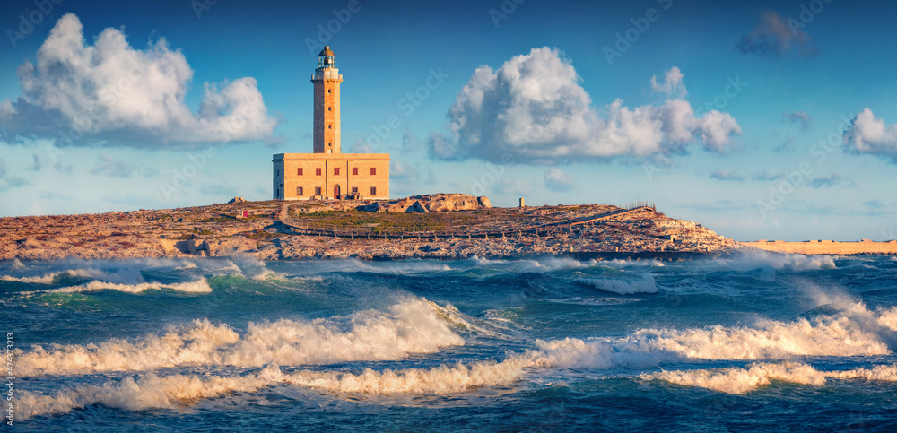 Stormy morning view of lighthouse in Vieste town. Breathtaking summer scene of Adriatic sea, Gargano National Park, Apulia region, Italy, Europe. Traveling concept background.