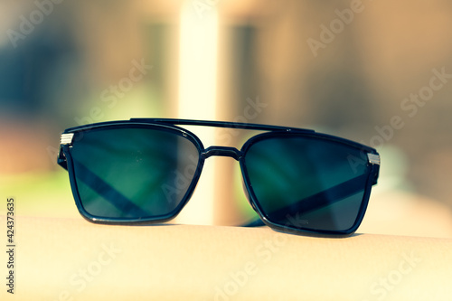 Oversized sunglasses model with big black lenses shoot outside in nature in a summer day closeup . Selective focus. High quality photo