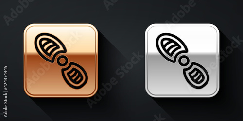 Gold and silver Human footprints shoes icon isolated on black background. Shoes sole. Long shadow style. Vector