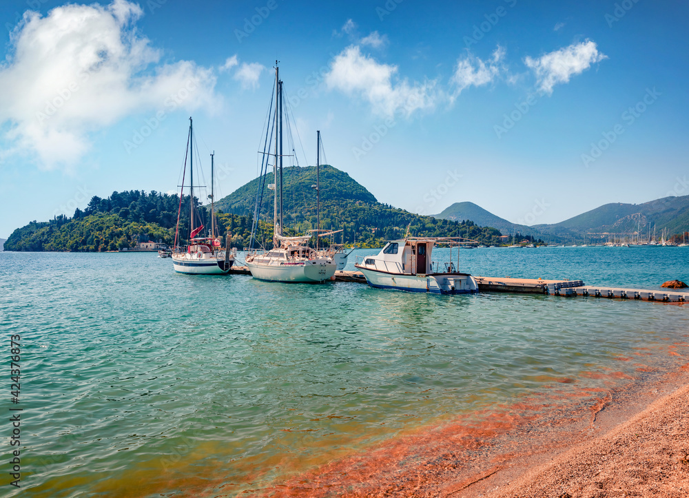 Exciting summer view of port Nydri. Calm morning seascape of Ionian Sea. Adorable  outdoor scene of Lefkada island, Greece, Europe. Traveling concept background.