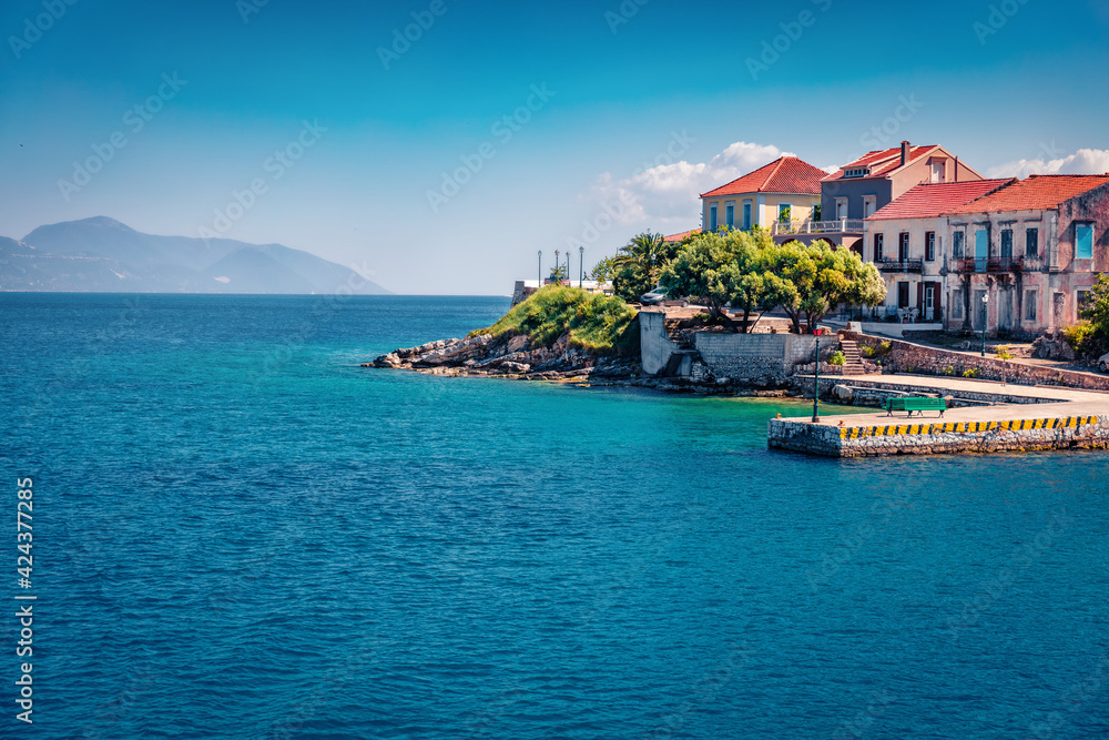 Сharm of the ancient cities of Europe. Exciting summer view of Fiskardo port. Sunny morning seascape of Ionian Sea. Bright outdoor scene of Kefalonia island, Greece, Europe.