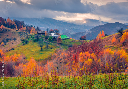 Beautiful autumn scenery. Dramatic morning view of Carpathian village. Incredible outdoor scene of mountain valley. Traveling concept background.