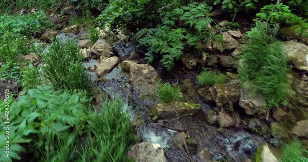 Mountain creek with cascade waterfall and rocky arch in wild nature reserve in Ural Mountains. Aerial drone wide shot at summer day. Mountain creek with cascade waterfall and rocky arch in wild nature reserve in Ural Mountains. Aerial drone wide shot at summer day.