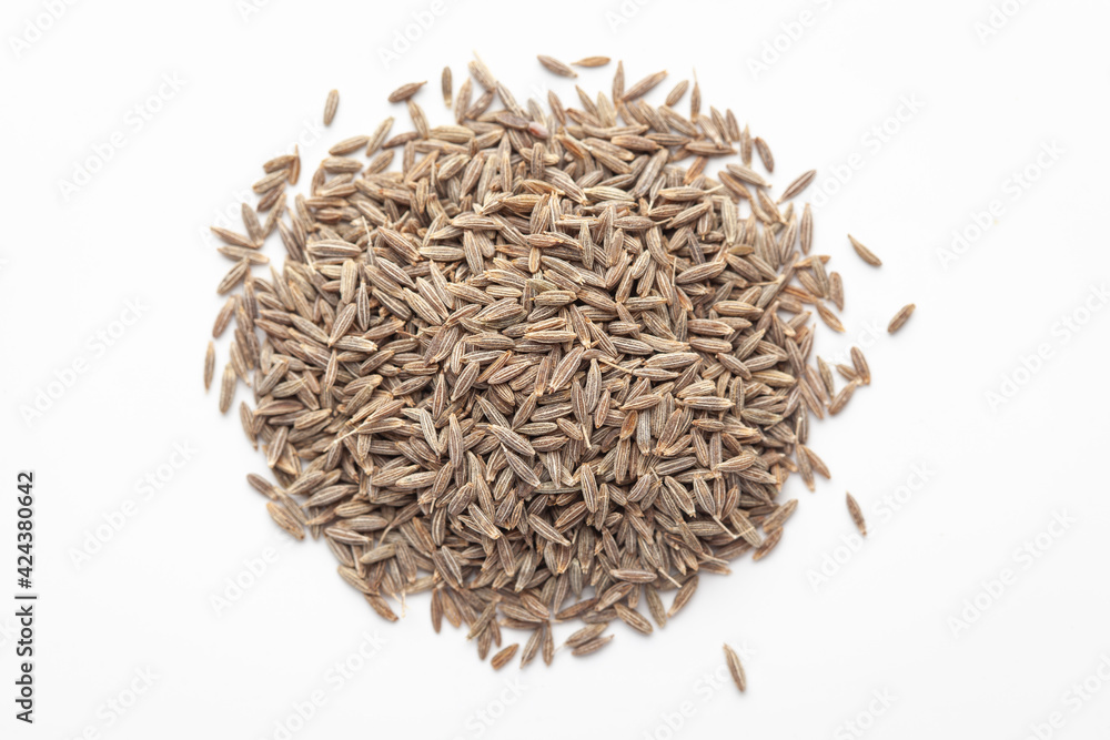 Macro close-up of Organic cumin seed (Cuminum cyminum) or jeera on white background. Pile of Indian Aromatic Spice. Top view Macro close-up of Organic cumin seed (Cuminum cyminum) or jeera on white background. Pile of Indian Aromatic Spice. Top view