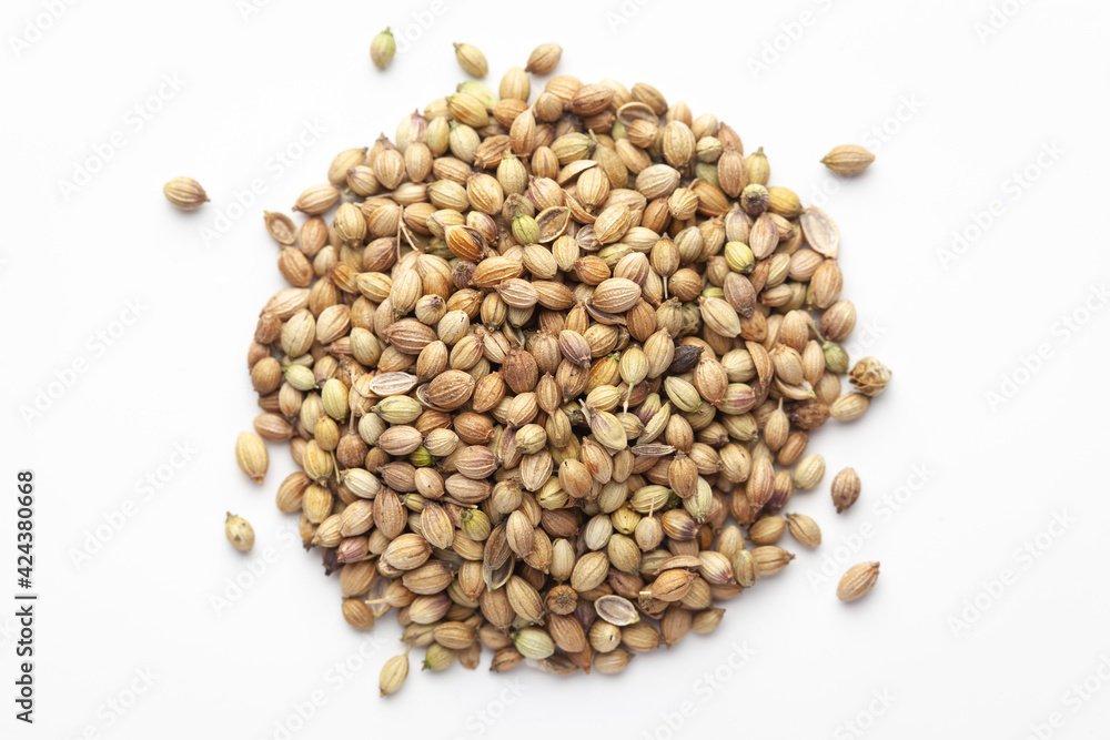 Macro close-up of Organic Coriander( Coriandrum sativum ) on white background. Pile of Indian Aromatic Spice. Top view Macro close-up of Organic Coriander( Coriandrum sativum ) on white background. Pile of Indian Aromatic Spice. Top view