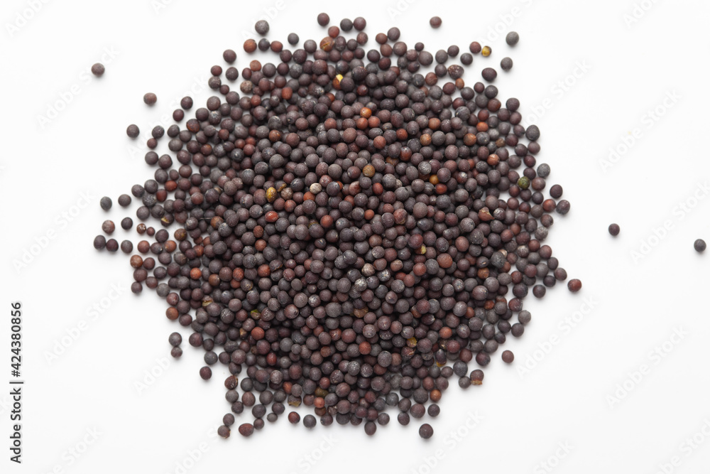 Macro close-up of Organic Black mustard seed (Brassica nigra) on white background. Pile of Indian Aromatic Spice. Top view Macro close-up of Organic Black mustard seed (Brassica nigra) on white background. Pile of Indian Aromatic Spice. Top view